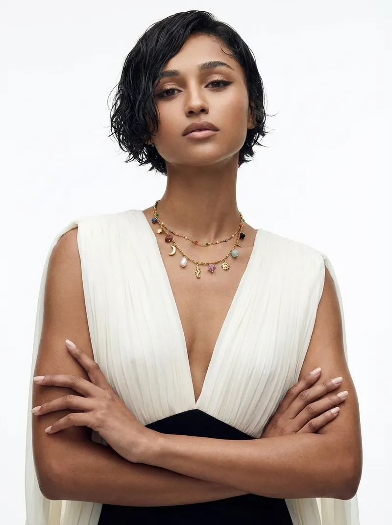 Blanc Luxe: white background, white draped dress, arms crossed