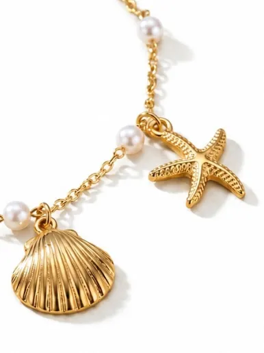Gold charm bracelet with starfish, shell, and pearl details, original product photo before AI processing